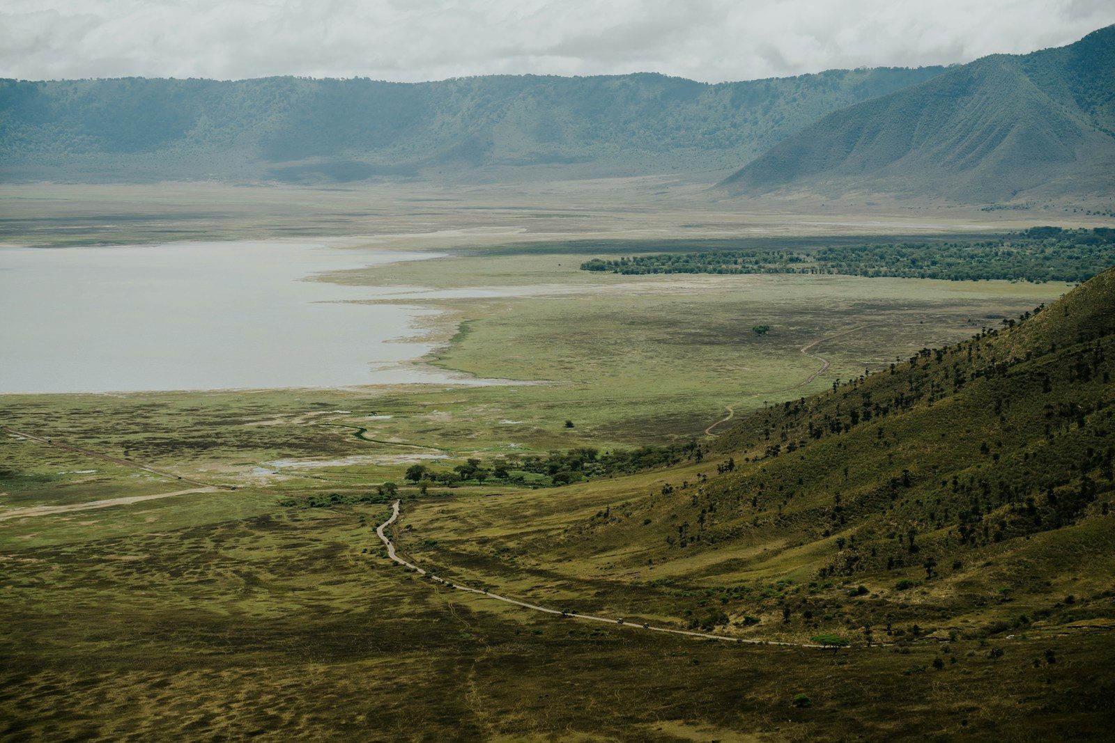 Vast landscape with lake and mountains visible.